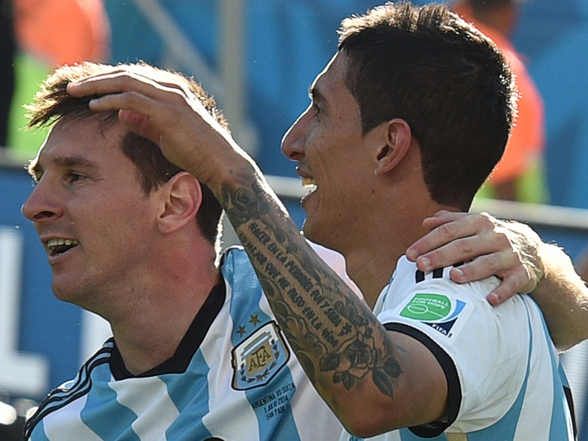Di Maria is congratulated by Messi after scoring against Switzerland in the World Cup