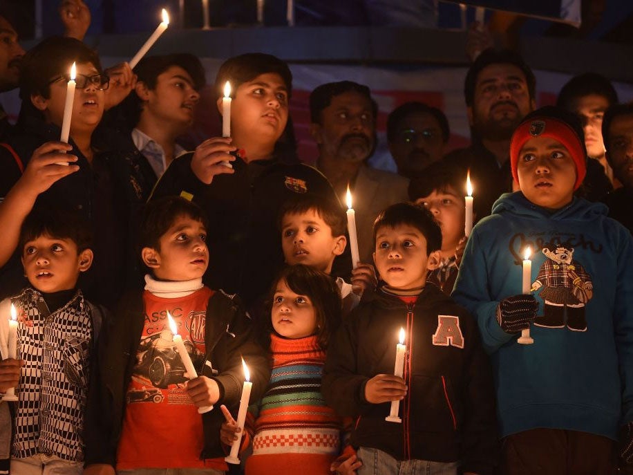 Pakistani political party workers, traders and students light candles during a vigil in Islamabad on December 18, 2014, for the children and teachers killed in an attack by Taliban militants on an army-run school in Peshawar.