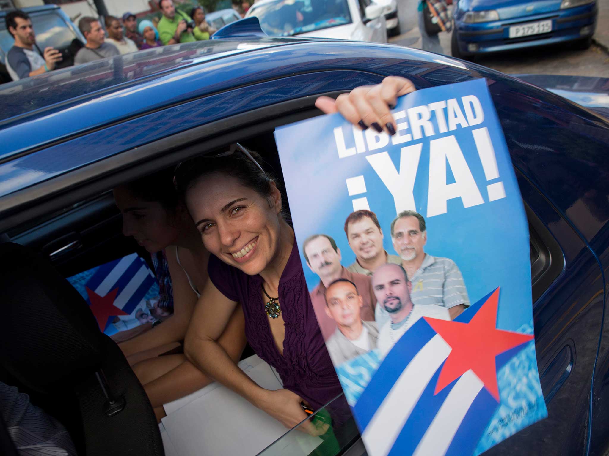 A campaigner holds a poster of the Cuban Five, the last of whom were released as part of US-Cuba talks