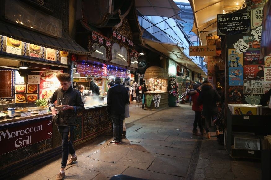 Shoppers peruse the shops and stalls around Camden Market in London