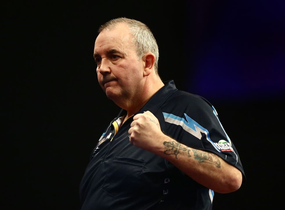 Phil Taylor celebrates his first round victory over Jyhan Artut