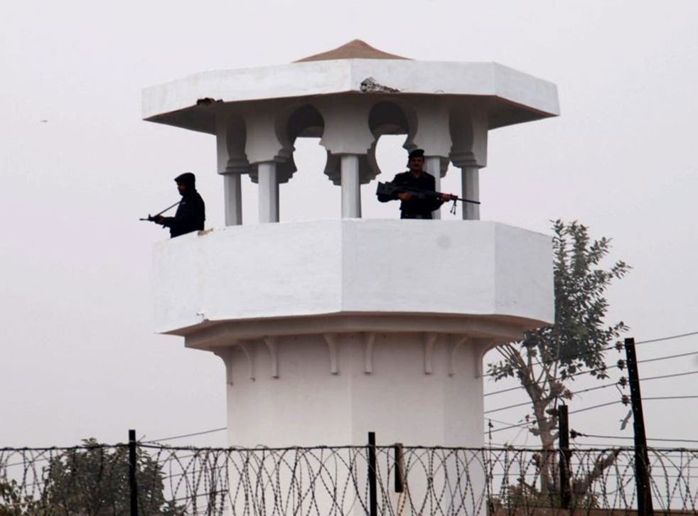 Pakistani police stand guard in the watch tower of Faisalabad central jail 