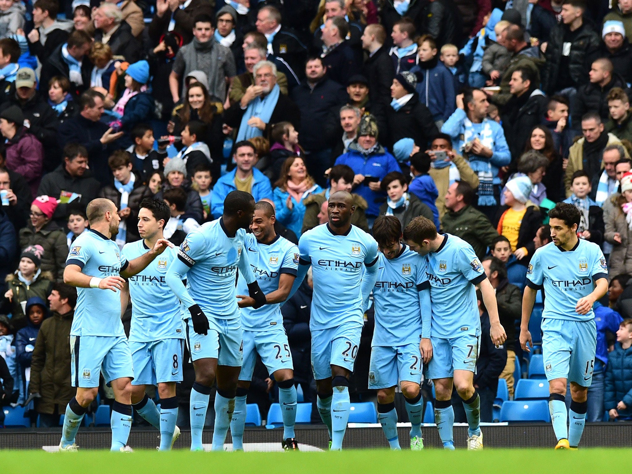 Manchester City players celebrate after David Silva's goal