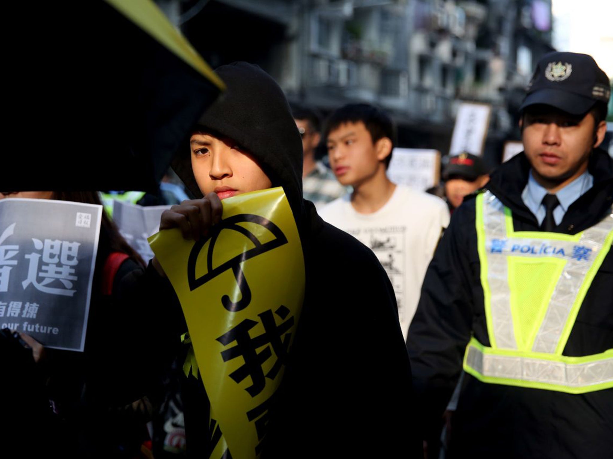 A pro-democracy protester in Macau calls for free leadership elections