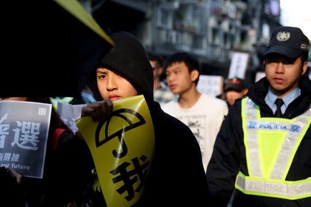 A pro-democracy protester in Macau calls for free leadership elections