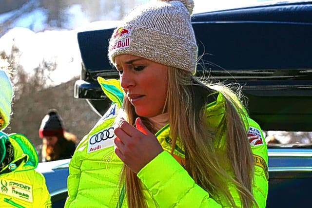 A disappointed Lindsey Vonn, with her right arm strapped up, leaves the course at Val d’Isère after crashing in the Super-G