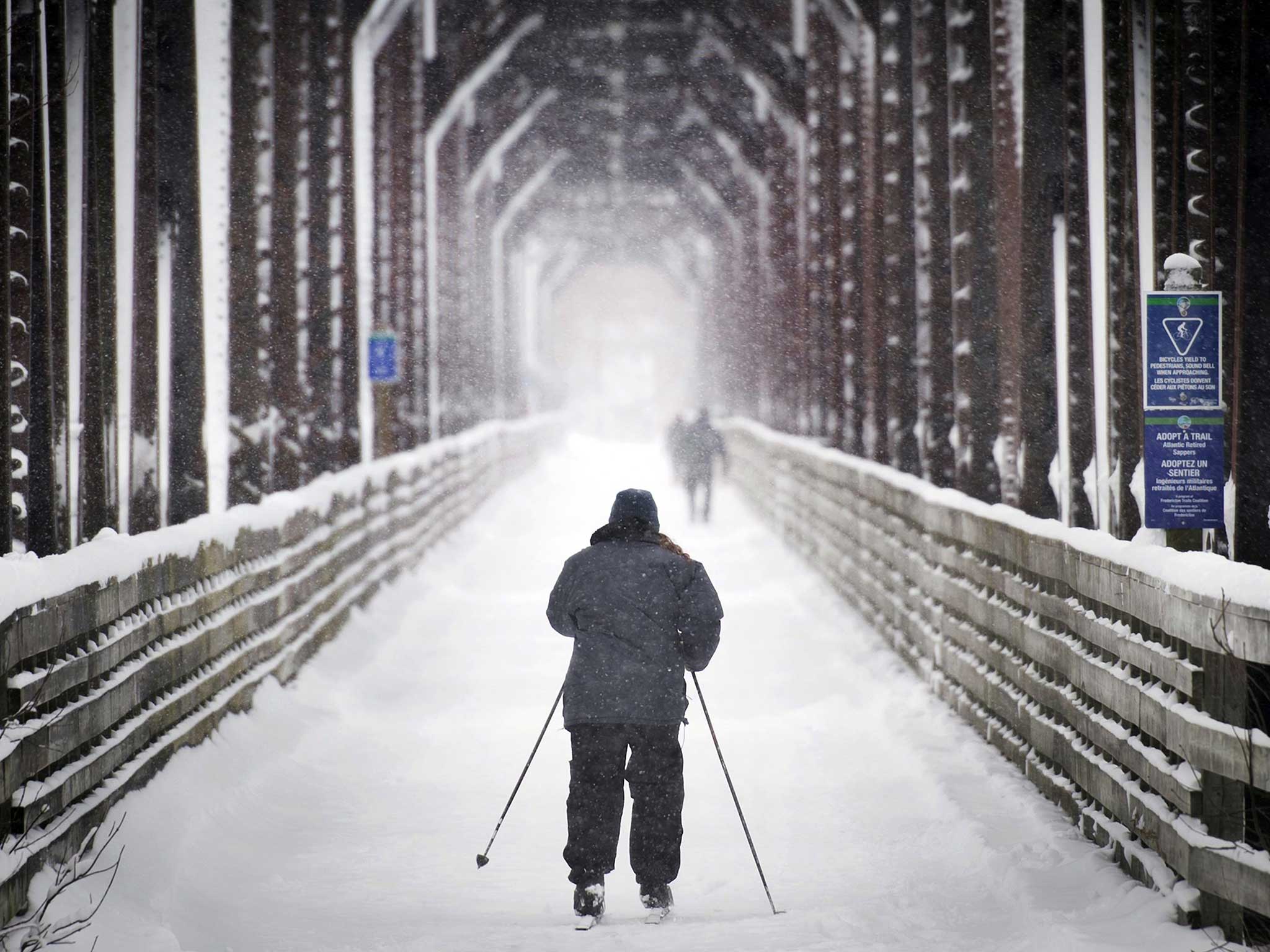 A man skis across the Bill Thorpe Walking Bridge in Fredericton, New Brunswick, last week