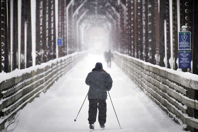 A man skis across the Bill Thorpe Walking Bridge in Fredericton, New Brunswick, last week