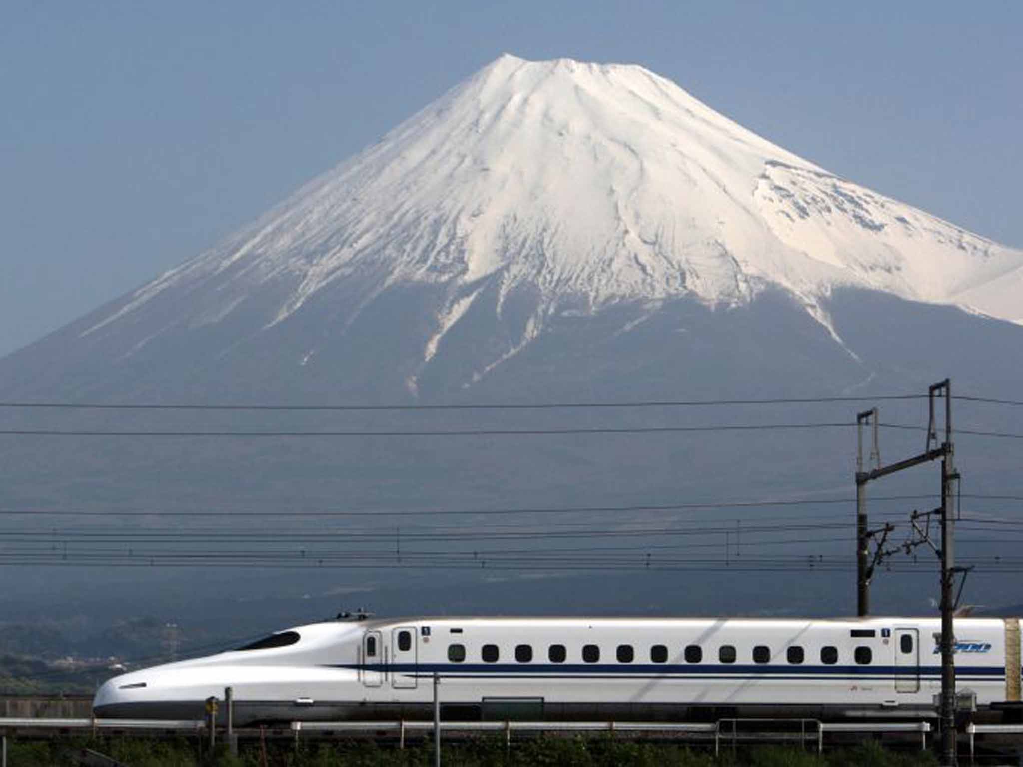A Shinkansen rushes past Mount Fuji