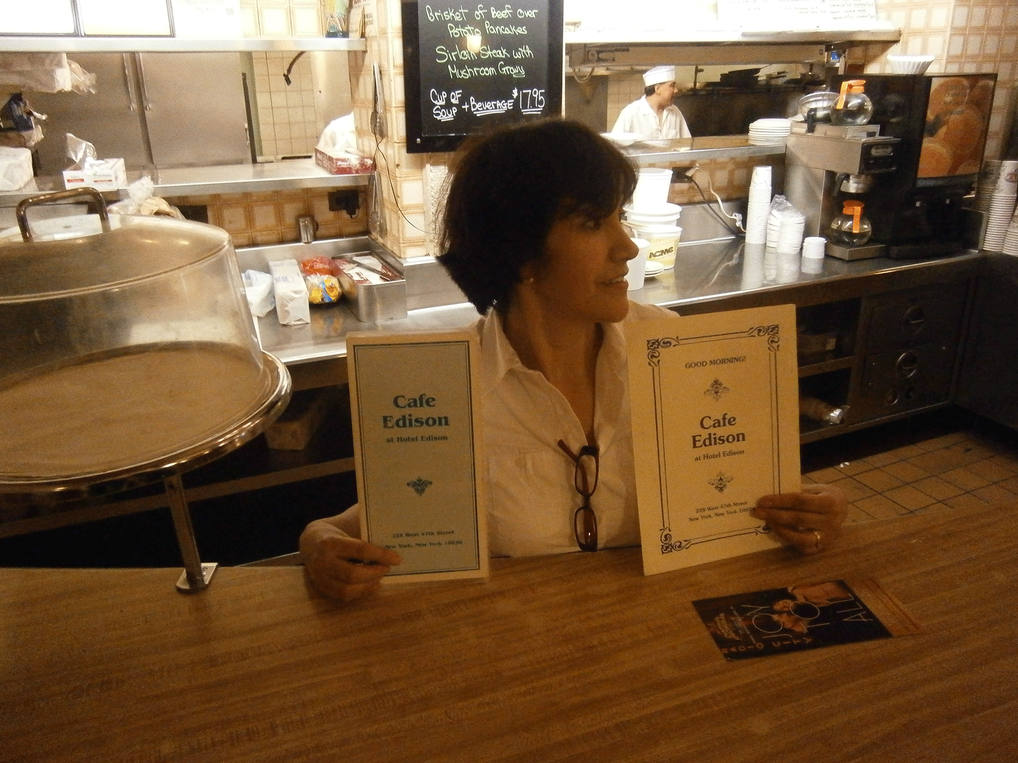 Waitress Luz Taylor displays menus at New York's Cafe Edison