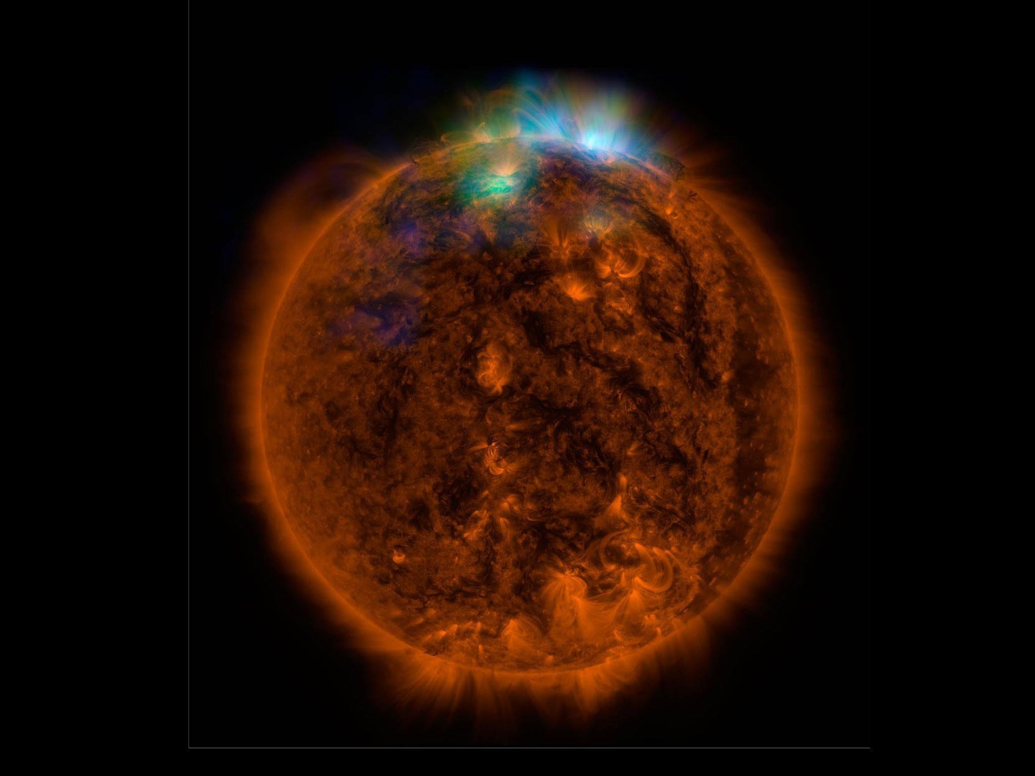 X-rays stream off the sun in this image showing observations from by NASA's Nuclear Spectroscopic Telescope Array, or NuSTAR, overlaid on a picture taken by NASA's Solar Dynamics Observatory (SDO)