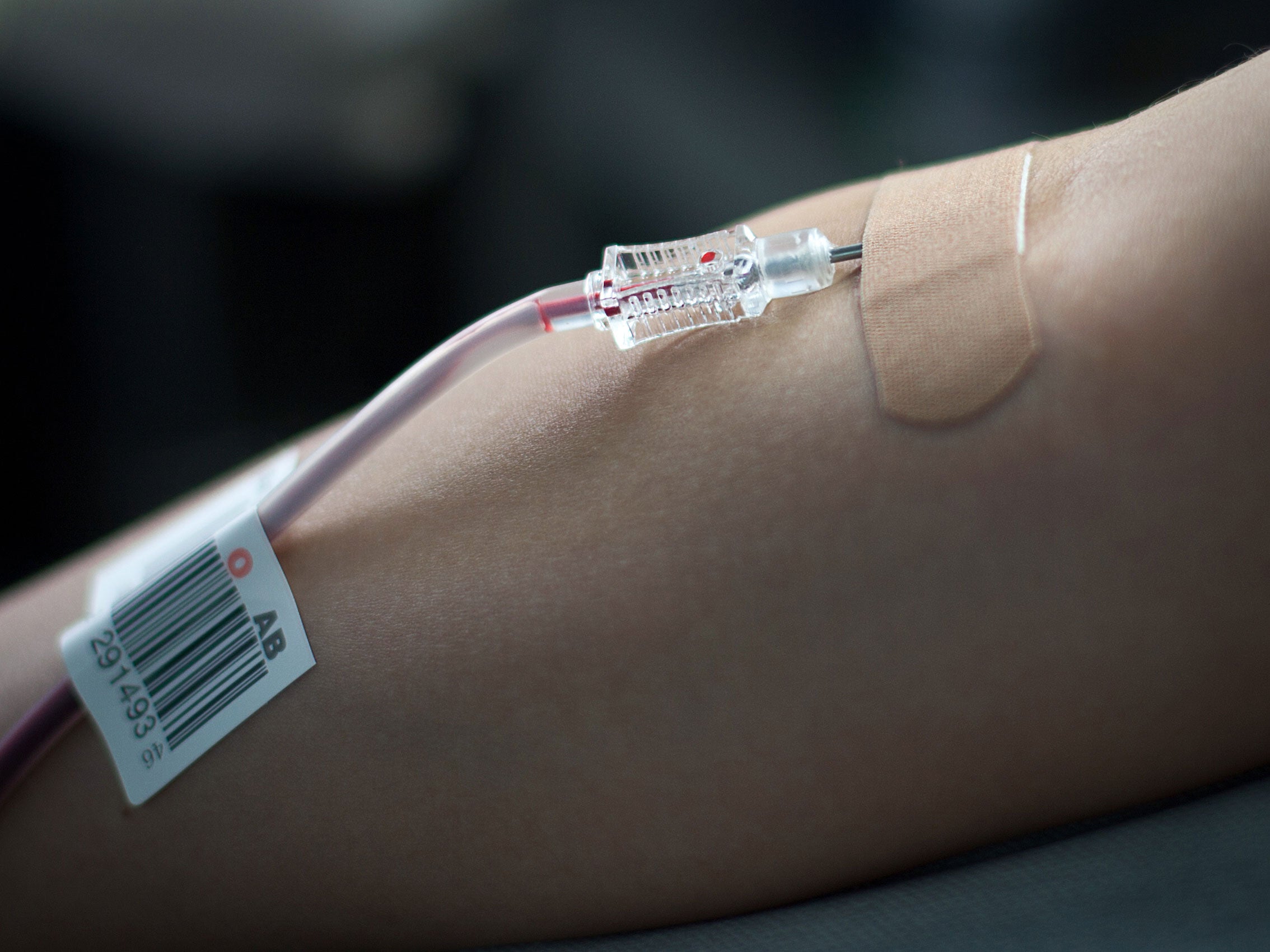 A woman gives blood