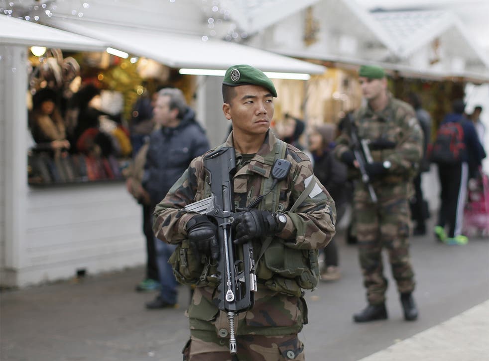 French soldiers patrol the Christmas market along the Champs Elysées in Paris as security forces step up protection of public places following acts of violence in Nantes, Dijon and Tours