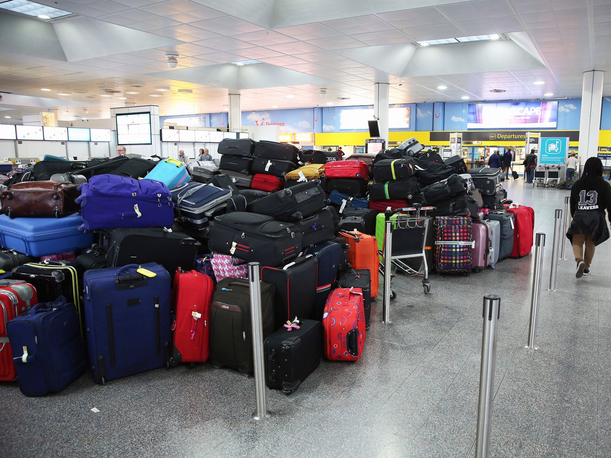 Passengers' hold luggage is stacked in the departure hall of Gatwick airport's North Terminal on Christmas Eve last year (Getty)