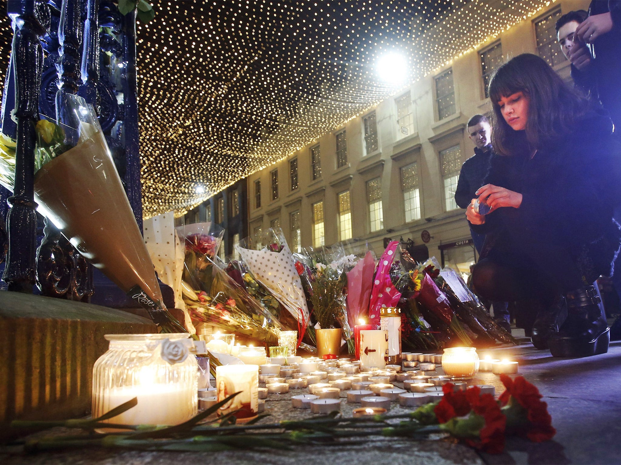 Candles and flowers are left near the Gallery of Modern Art as the city reopens after the bin lorry crash on Sunday
