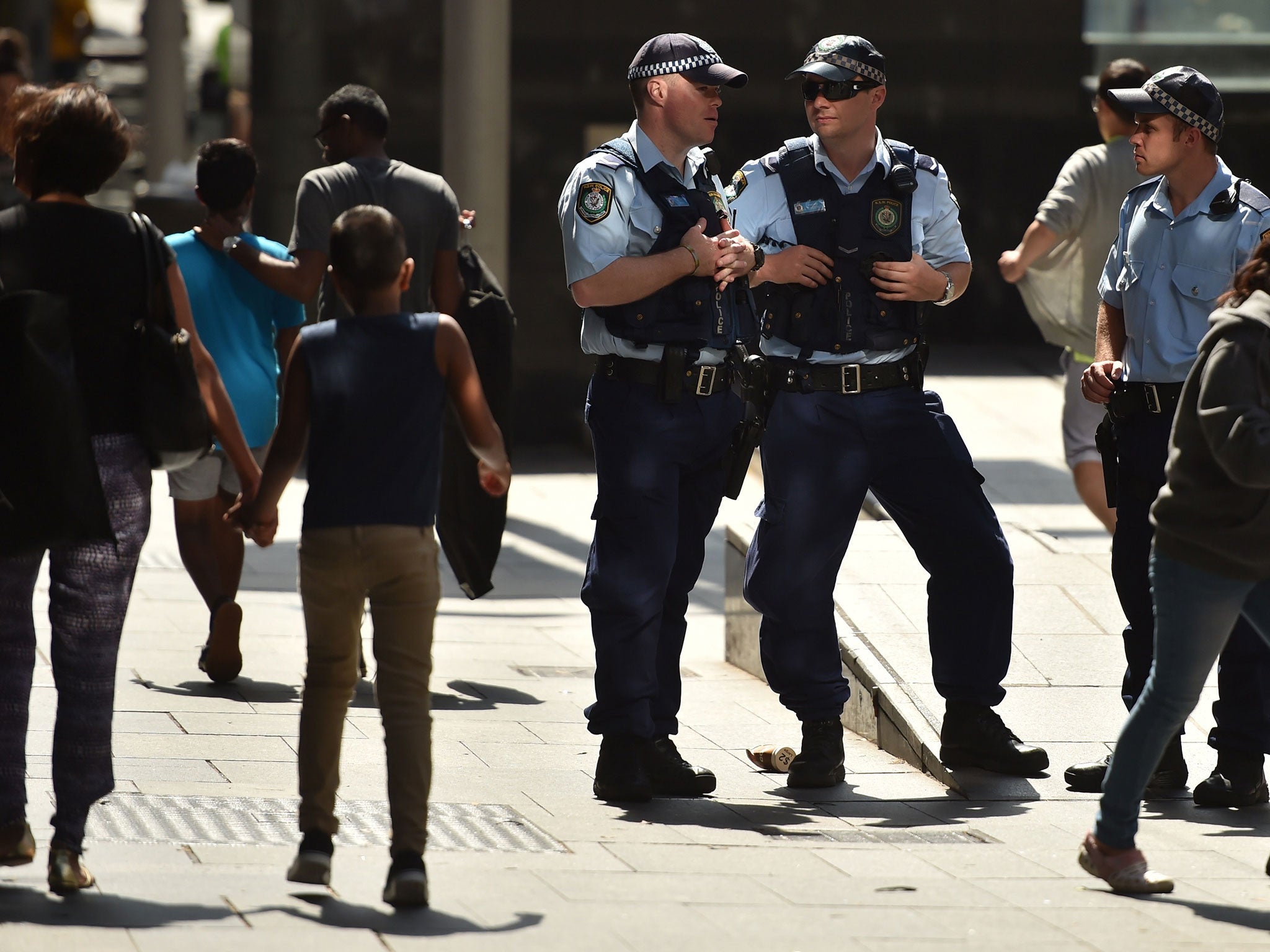 Police patrol the street in Sydney's central business district on December 24, 2014.