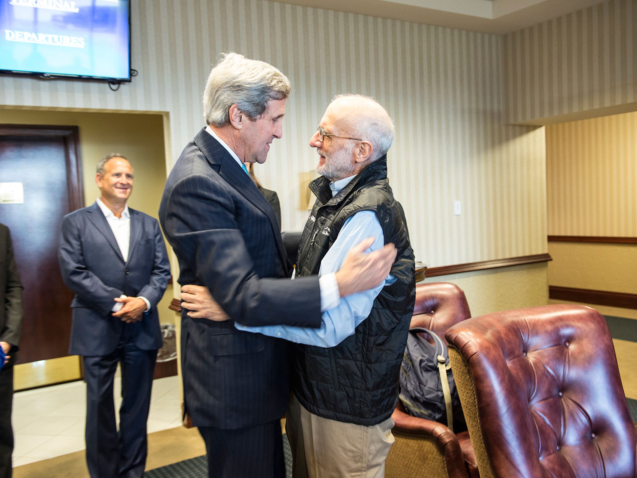 Alan Gross with Secretary of State John Kerry after being released from Cuban custody
