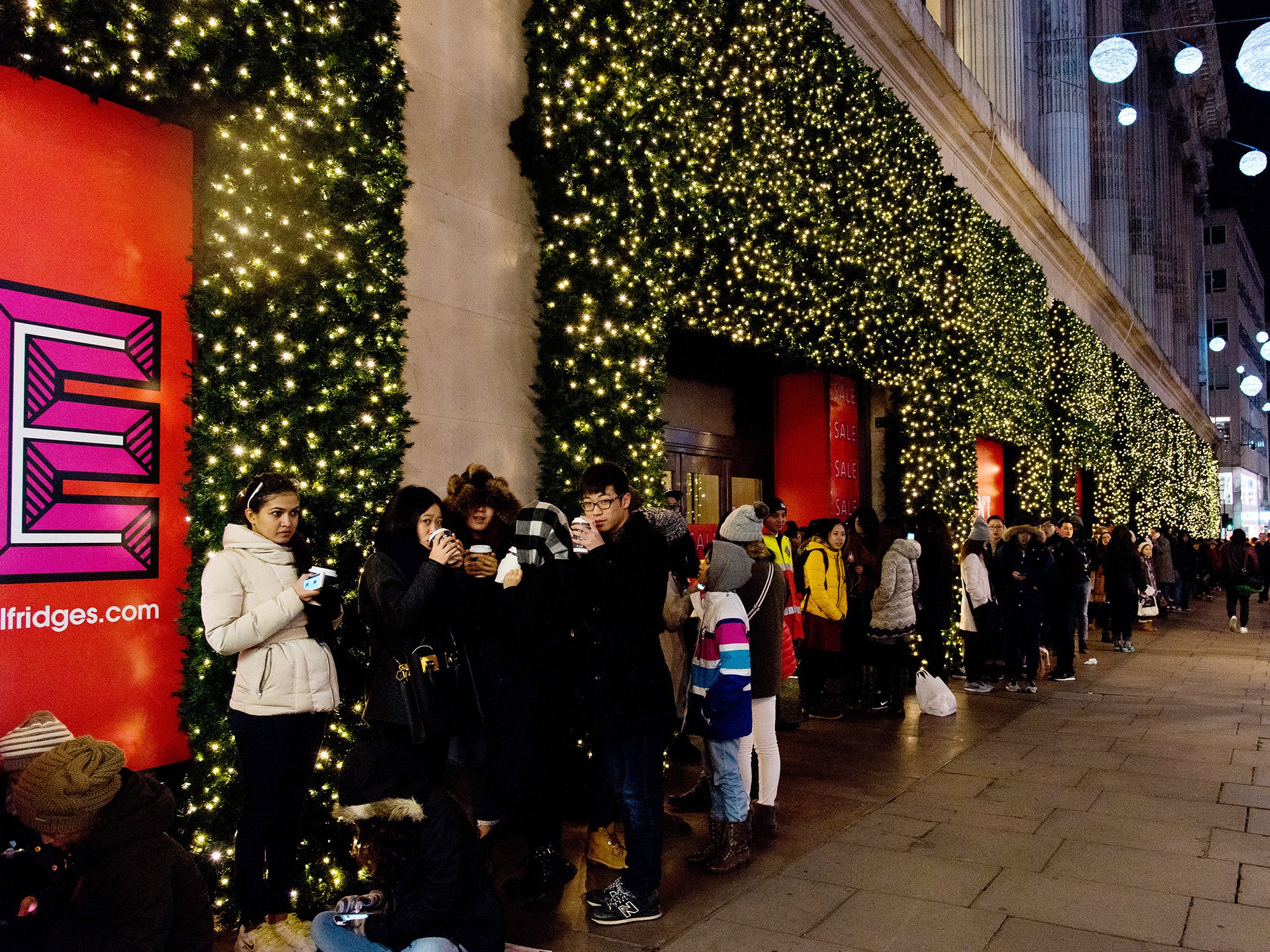 People queue for the shops to open in London for the Boxing Day sales