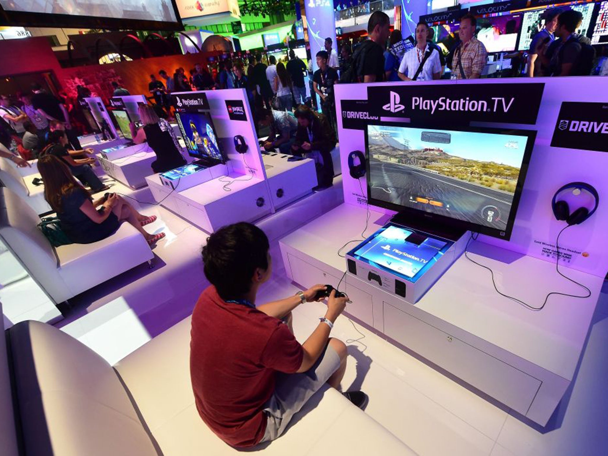 Gamers test the new PlayStation TV consoles at the E3 event in Los Angeles