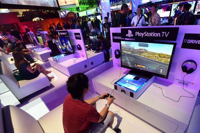 Gamers test the new PlayStation TV consoles at the E3 event in Los Angeles