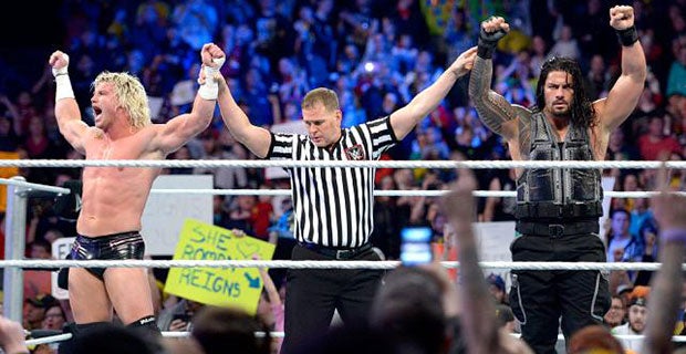 Dolph Ziggler and Roman Reigns celebrate their victory over Seth Rollins and the Big Show
