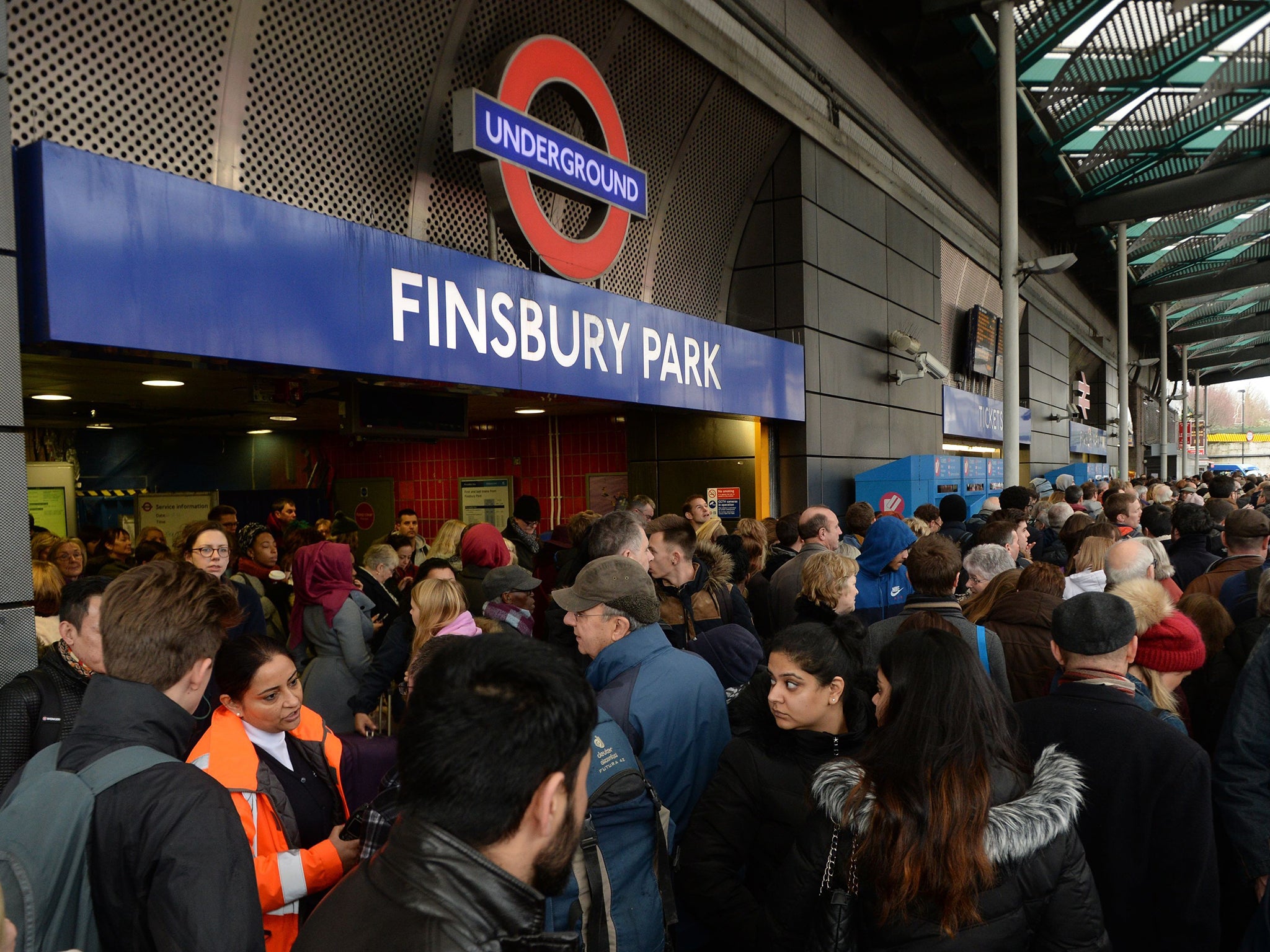 Travellers are locked out of Finsbury Park station, London, where they were directed to go as trains in and out of King's Cross have been cancelled