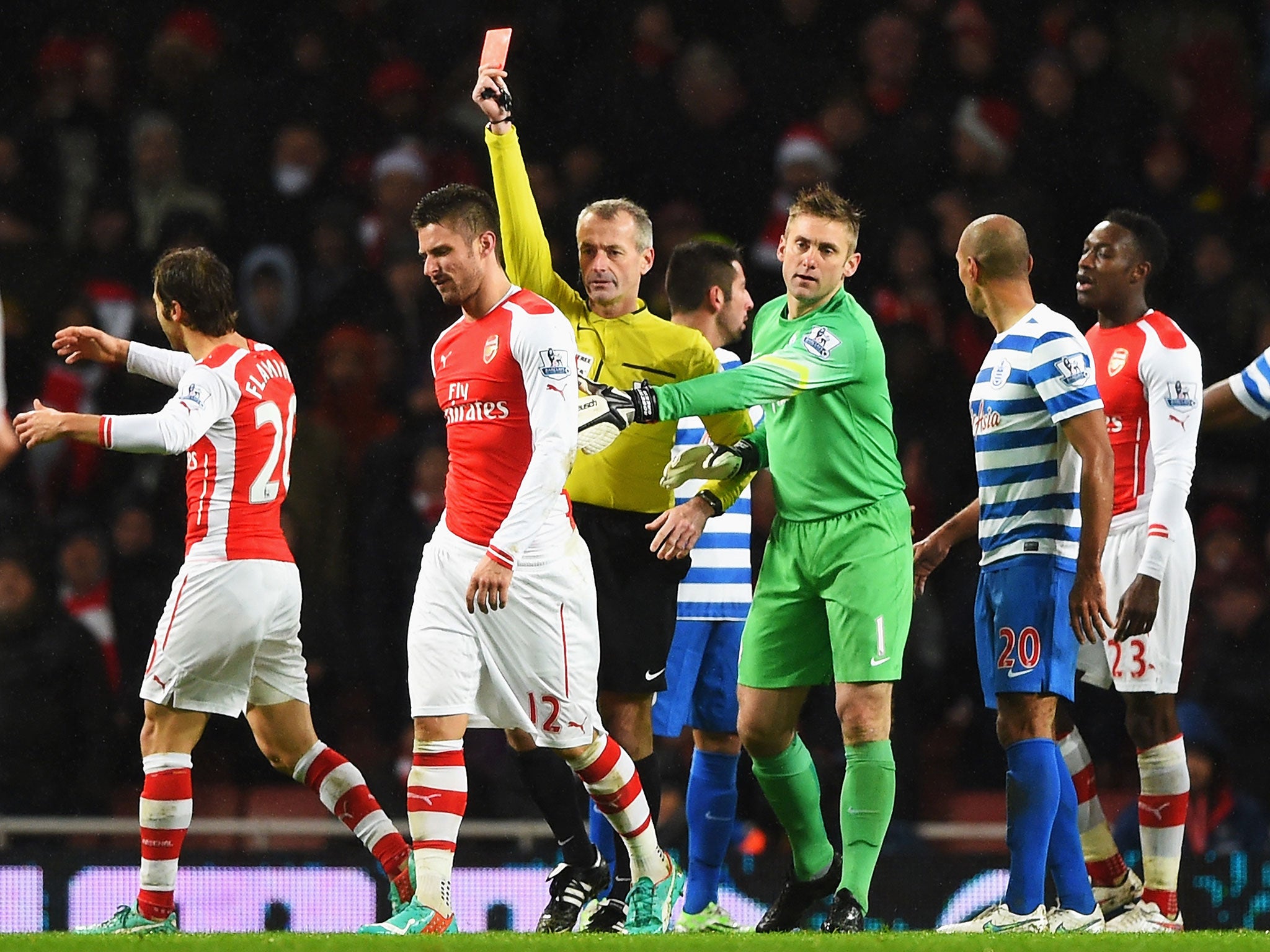 Olivier Giroud is shown a straight red card by referee Martin Atkinson after head-butting Nedum Onouha