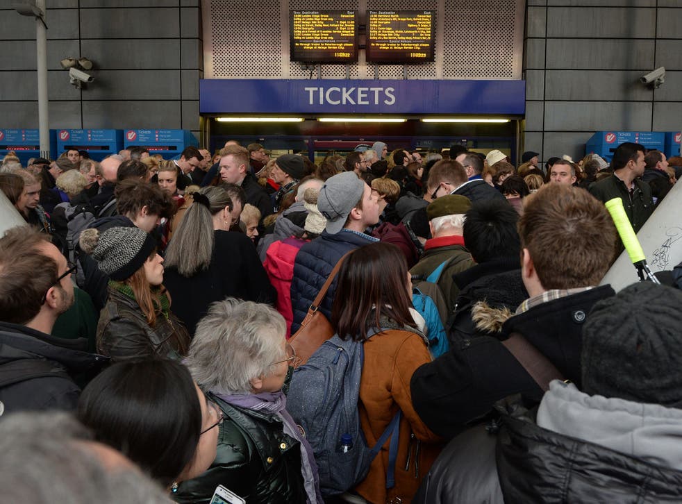 People wait outside Finsbury Park station, London, on 27 December 2014