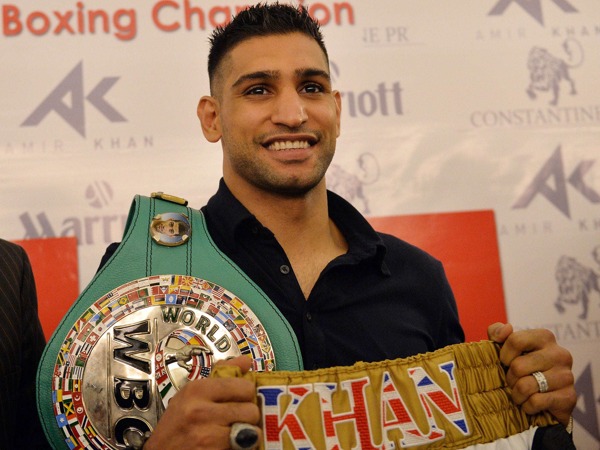 Hitting out: Amir Khan arrives in Islamabad with his world-title belt