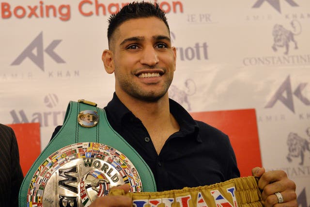 Hitting out: Amir Khan arrives in Islamabad with his world-title belt