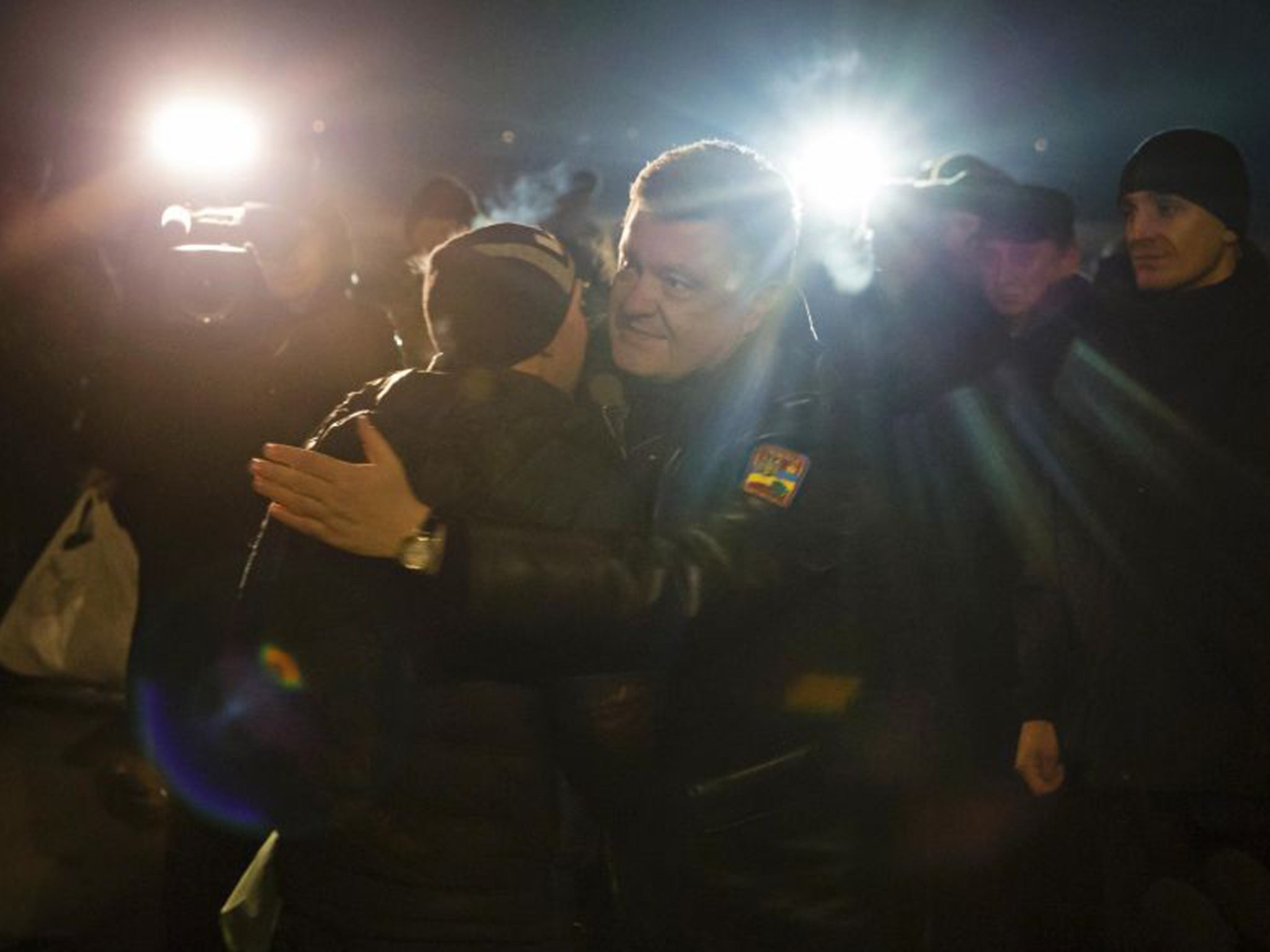 Ukraine’s President Petro Poroshenko hugs a freed prisoner