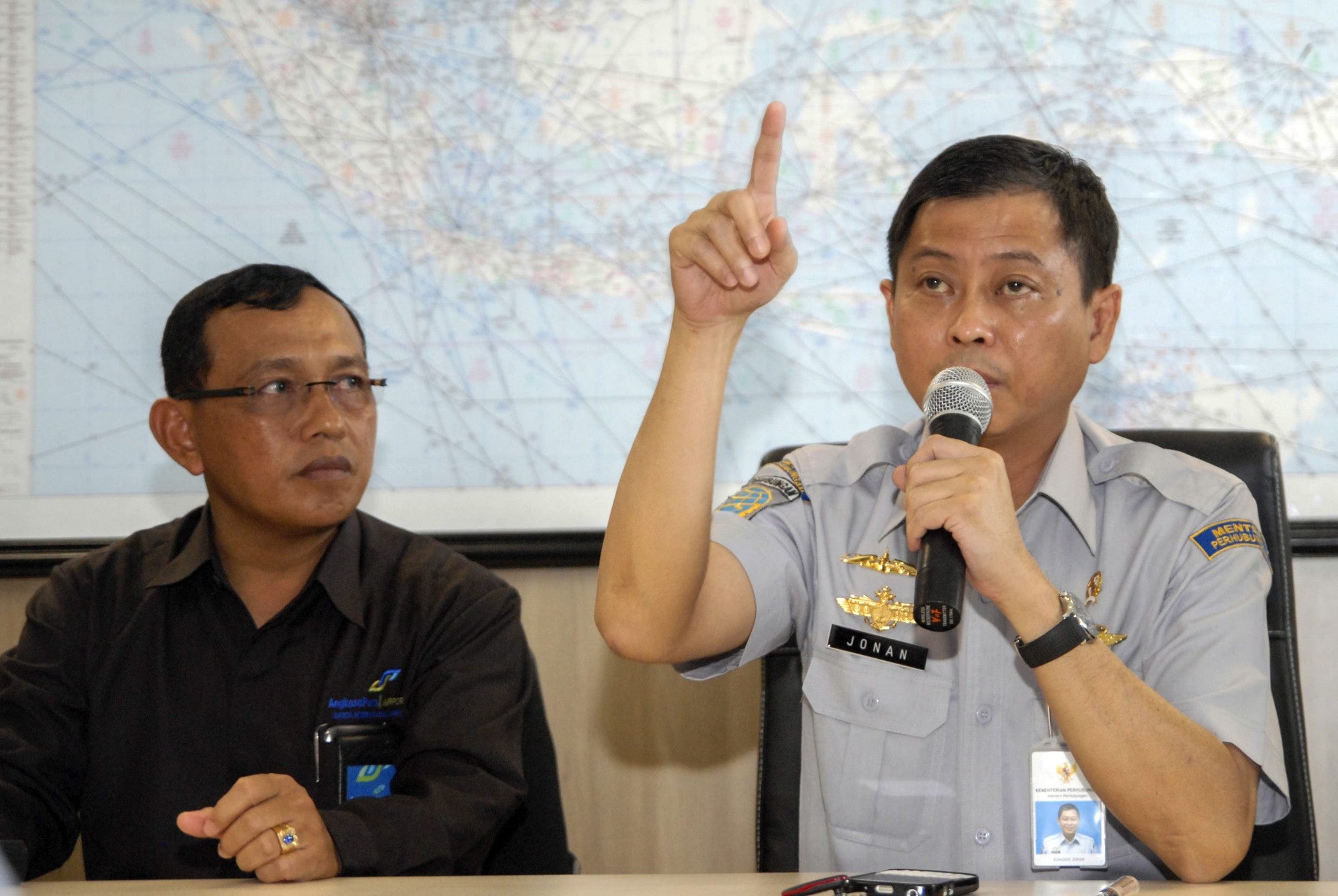 Indonesian Minister of Transportation Ignasius Jonan (right) talks to journalists during a press conference