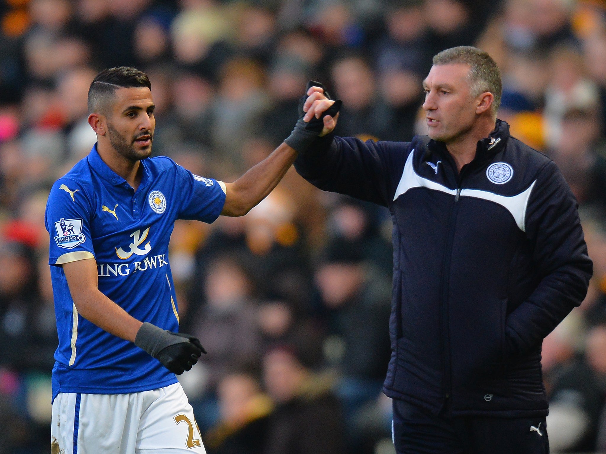 Nigel Pearson, manager of Leicester City congratulates Riyad Mahrez of Leicester City on the scoring the opening goal