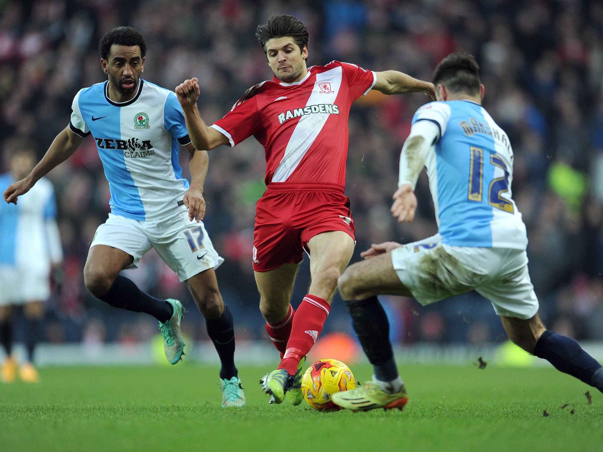 Lee Williamson (L) and Ben Marshall (R) of Blackburn Rovers tackle George Friend (C) of Middlesbrough