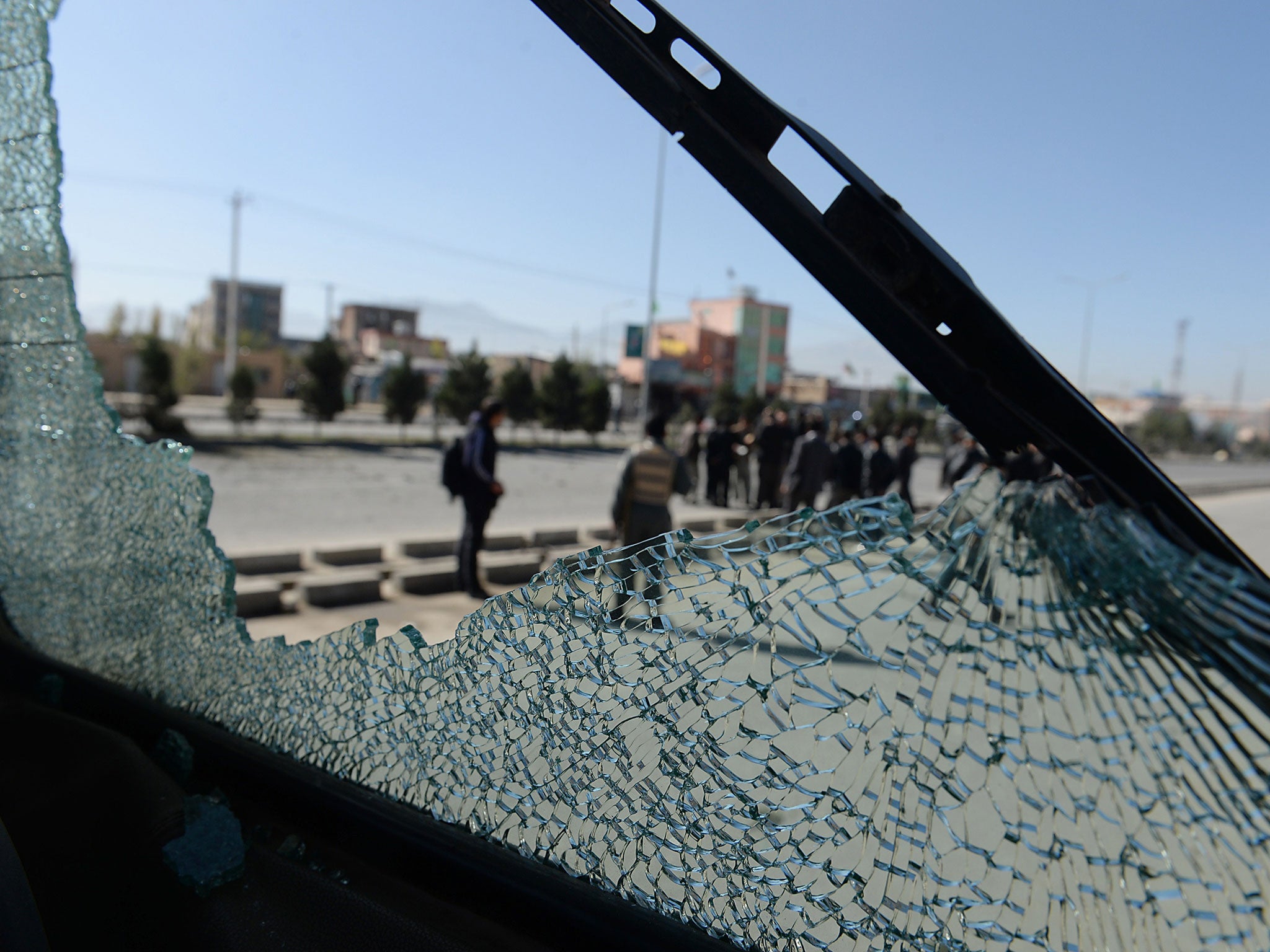 Afghan forces are seen through the shattered glass of a bus caught in a roadside bombing in Kabul. Improvised explosives are one of the main causes of civilian casualties