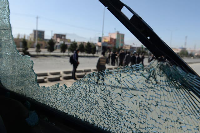 Afghan forces are seen through the shattered glass of a bus caught in a roadside bombing in Kabul. Improvised explosives are one of the main causes of civilian casualties