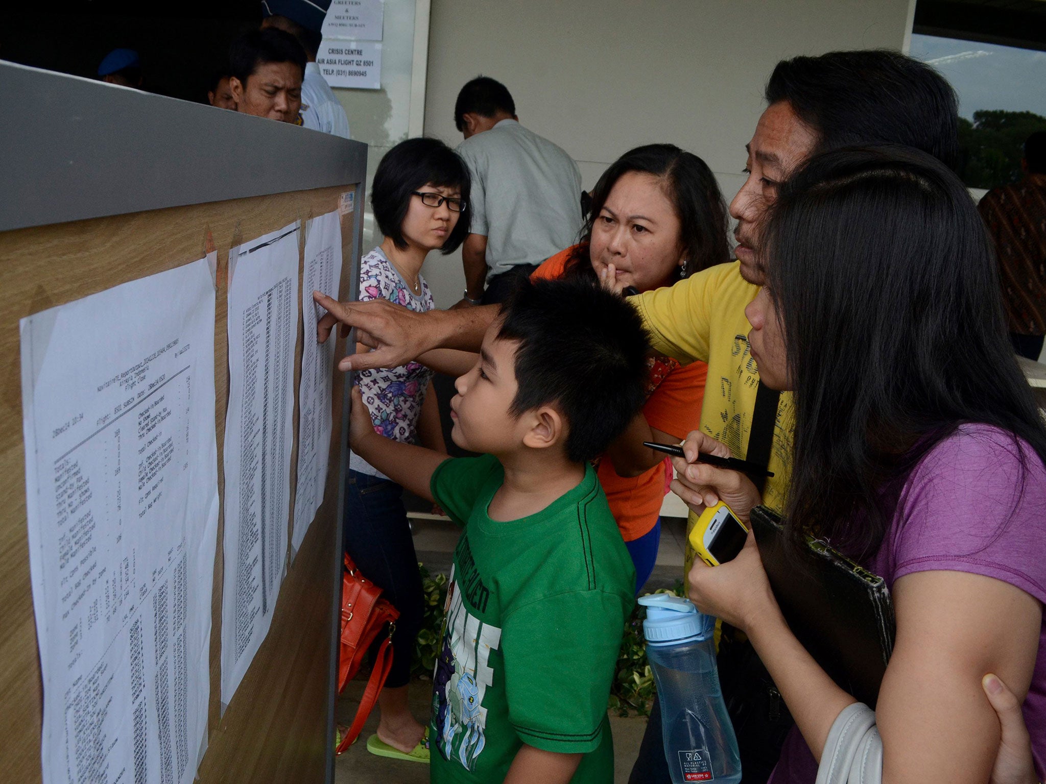 Relatives scour the passenger list of the missing flight