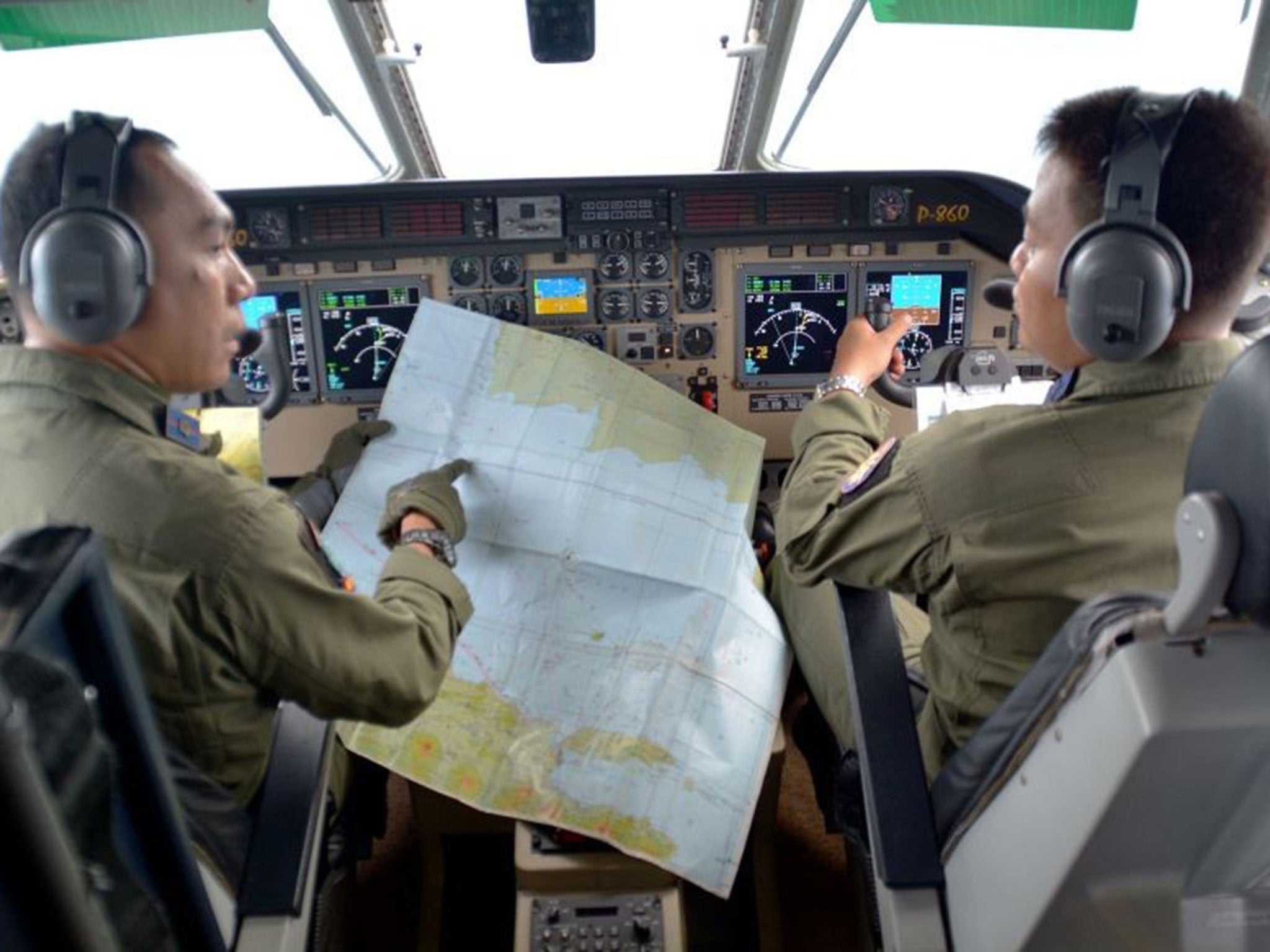 Indonesian navy pilots flying over the Java Sea during joint search operations for the AirAsia flight