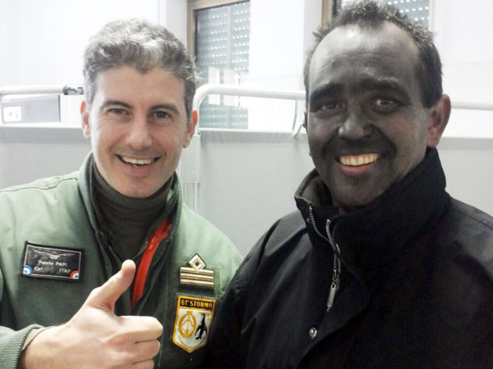 Briton Nick Channing-Williams, covered in soot, with Captain Paolo Papi of the Italian Air Force (PA)
