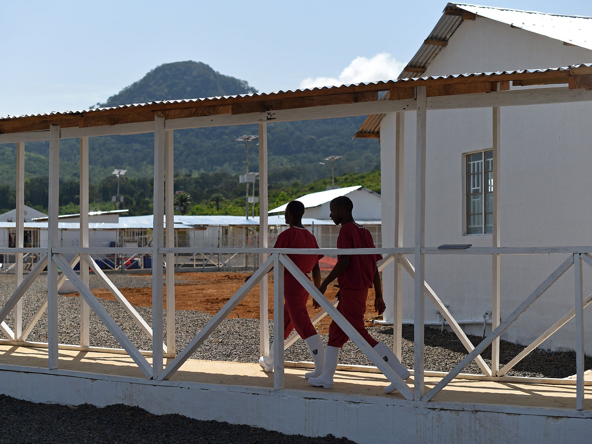 Health workers walk on November 13, 2014, on Kerry Town treatment centre (Getty Images)