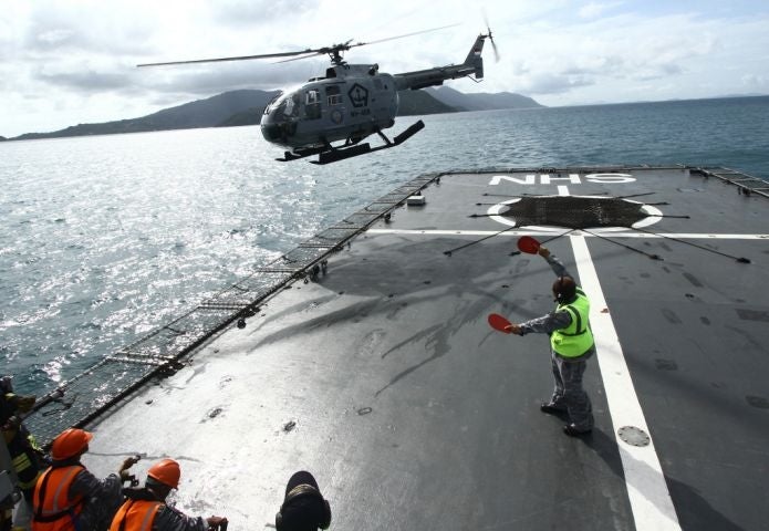 An Indonesian Navy helicopter assists in the search for debris from AirAsia flight QZ8501 near Batam, south of Singapore