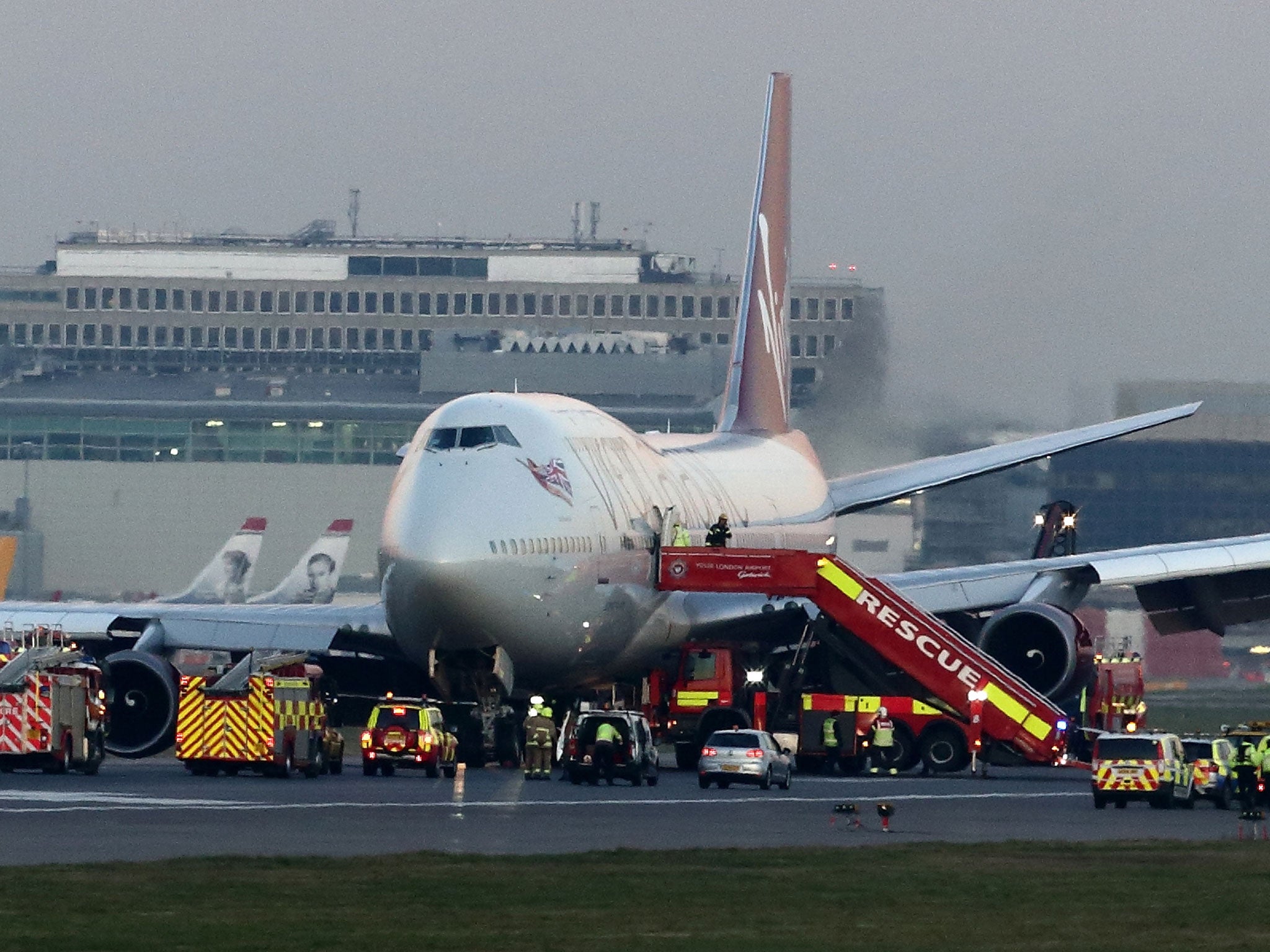 Emergency vehicles attend to the Virgin Atlantic Boeing 747 at Gatwick airport in West Sussex in London