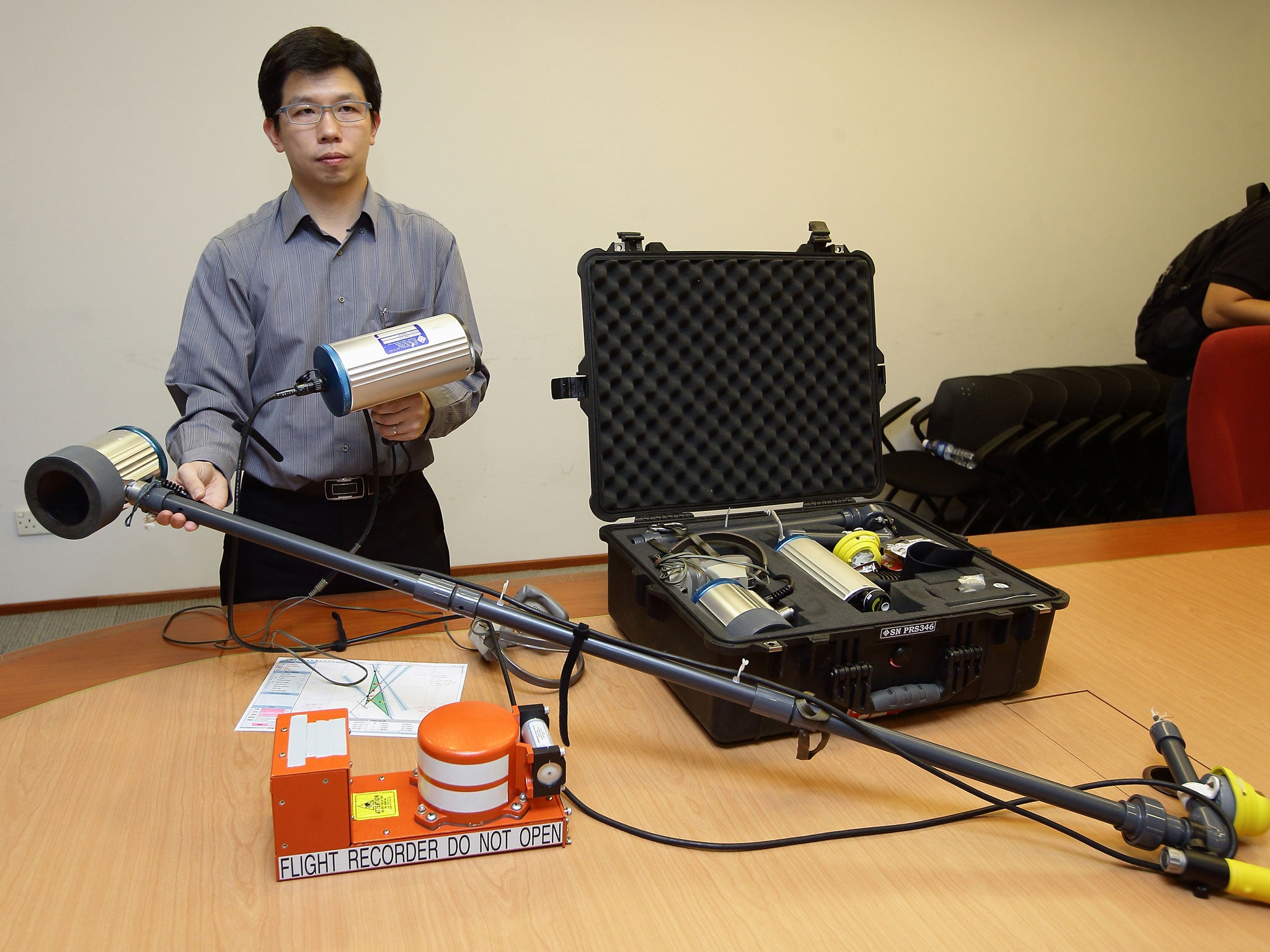 A specialist from the Singapore Ministry of Transport's Accident Investigation Bureau (AAIB) gives a short demo on the underwater locator beacon detectors (Getty Images)