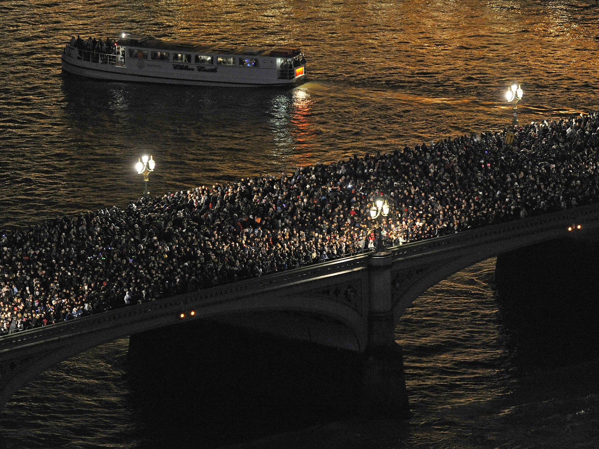 31 December 2012: Crowds on Westminster Bridge in central London as they wait for the New Year's Eve fireworks