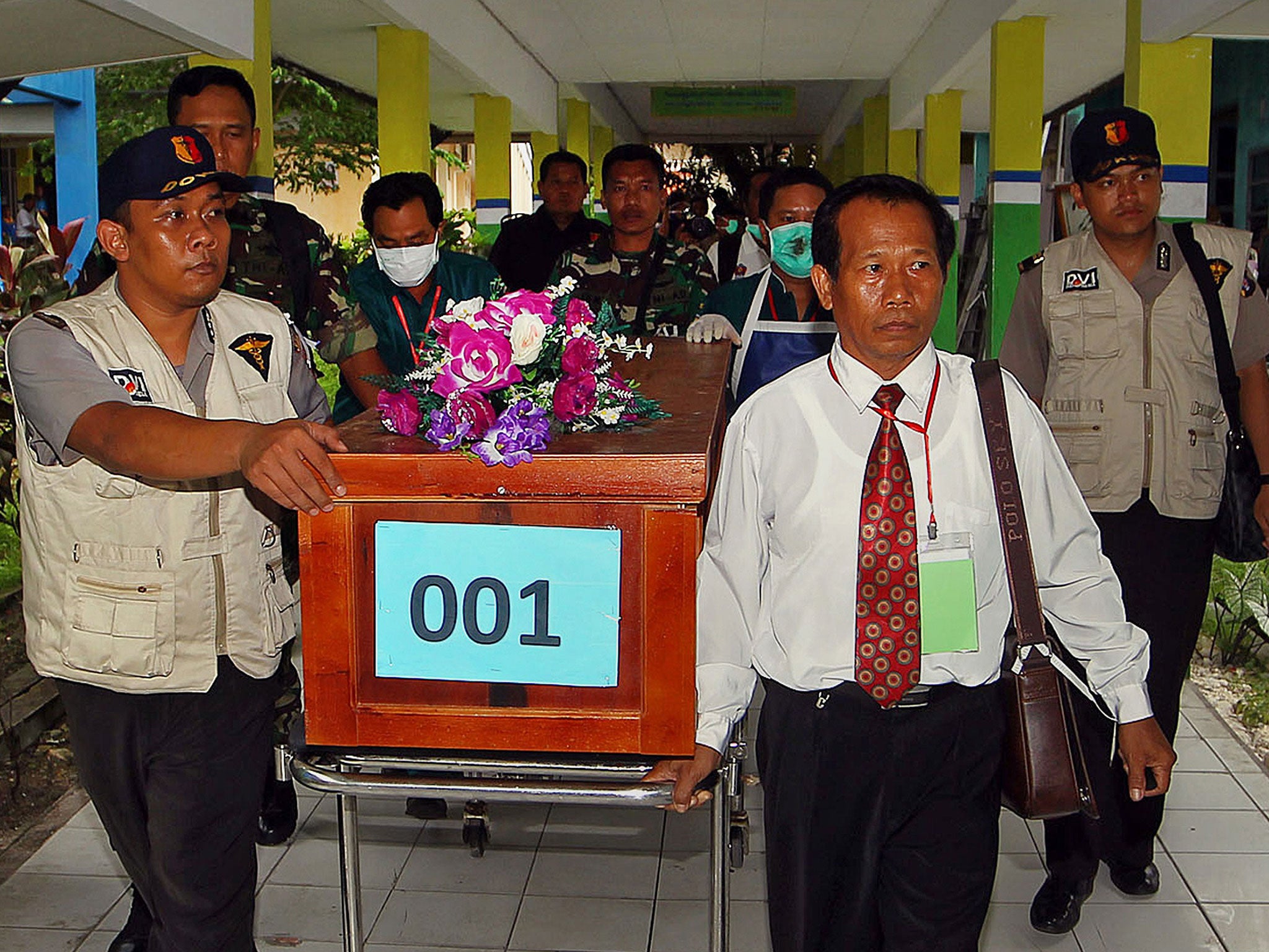 A coffin of a victim of AirAsia flight QZ8501 is transferred from a local hospital in Pangkalan Bun, the town with the nearest airstrip to the crash site of AirAsia flight QZ8501, in Central Kalimantan