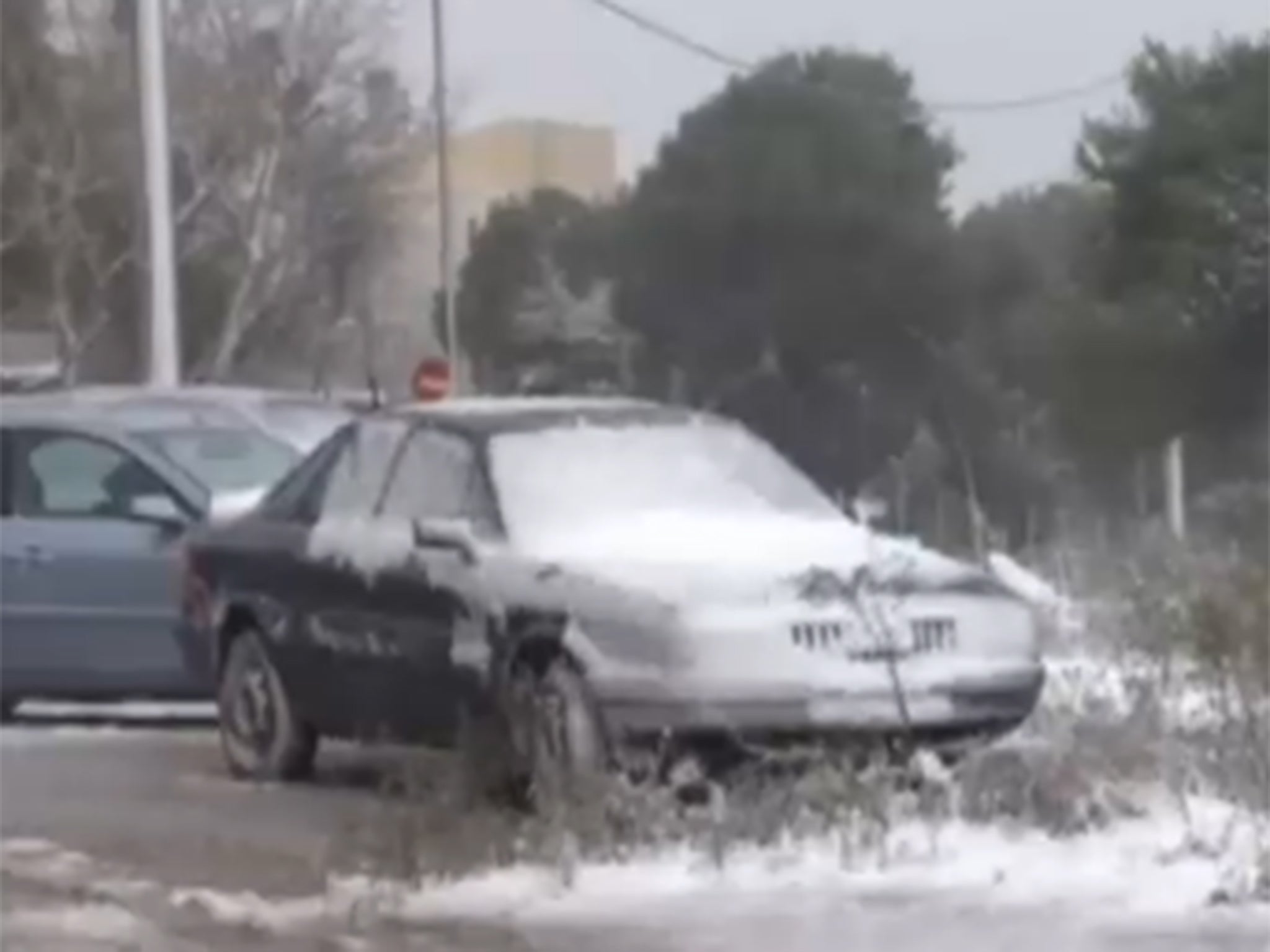 A car is coated in snow as Greece experiences a spell of severe winter weather