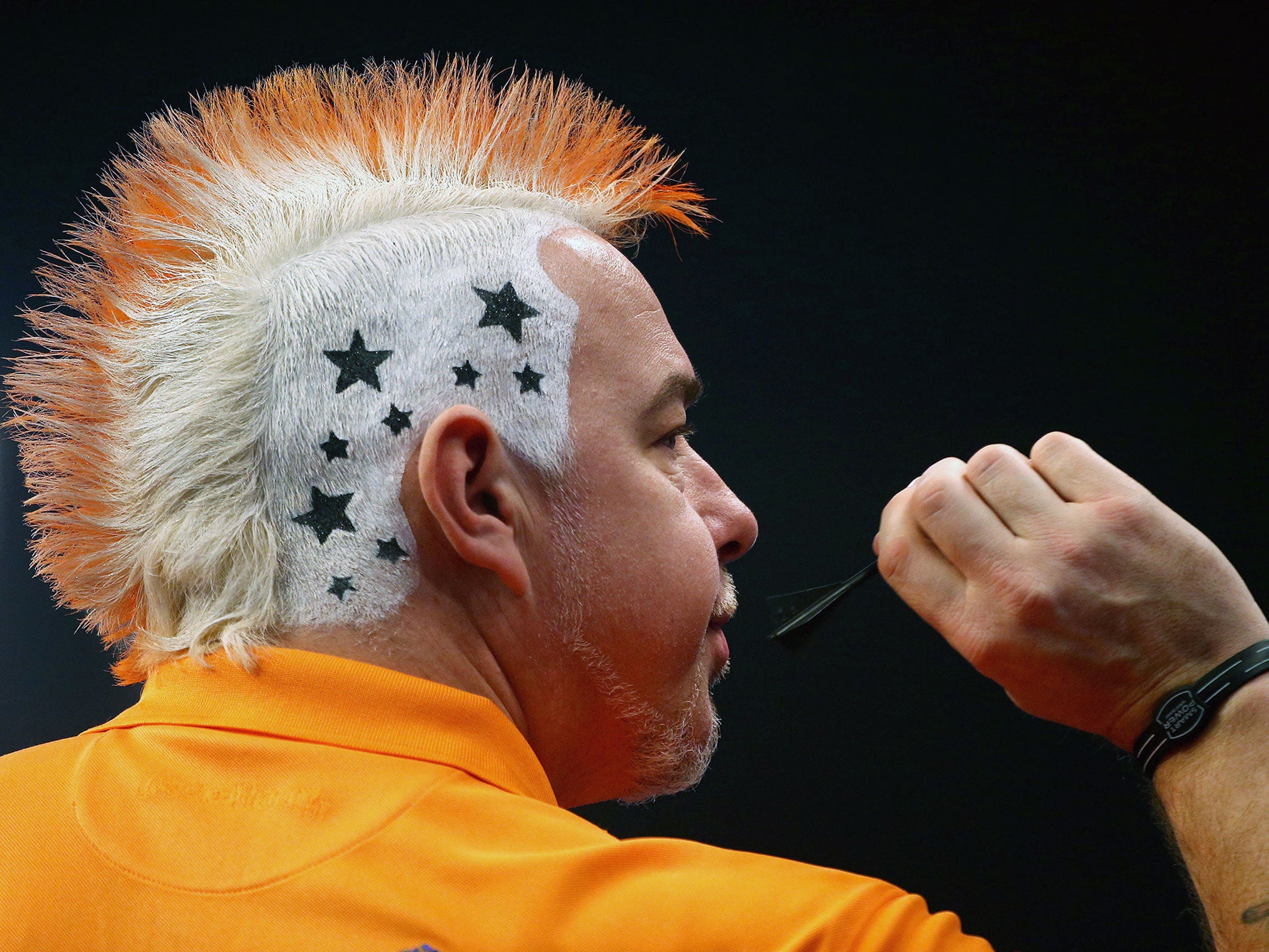 Peter Wright of Scotland shows off his hair style during his third round match against Andy Hamilton of England during the William Hill PDC World Darts Championships on Day Ten at Alexandra Palace in London