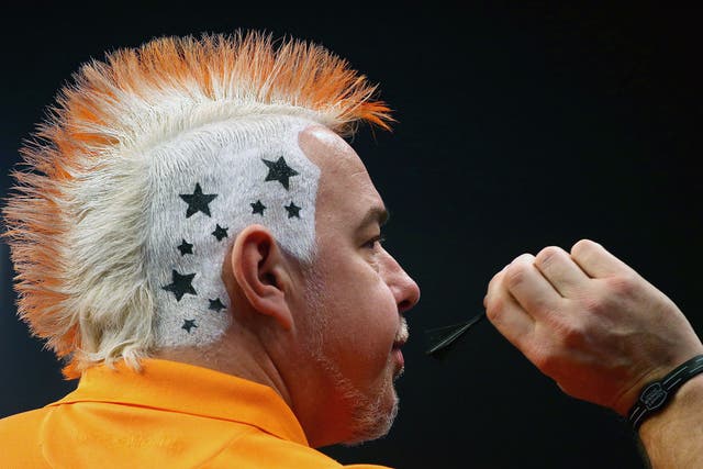 Peter Wright of Scotland shows off his hair style during his third round match against Andy Hamilton of England during the William Hill PDC World Darts Championships on Day Ten at Alexandra Palace in London 