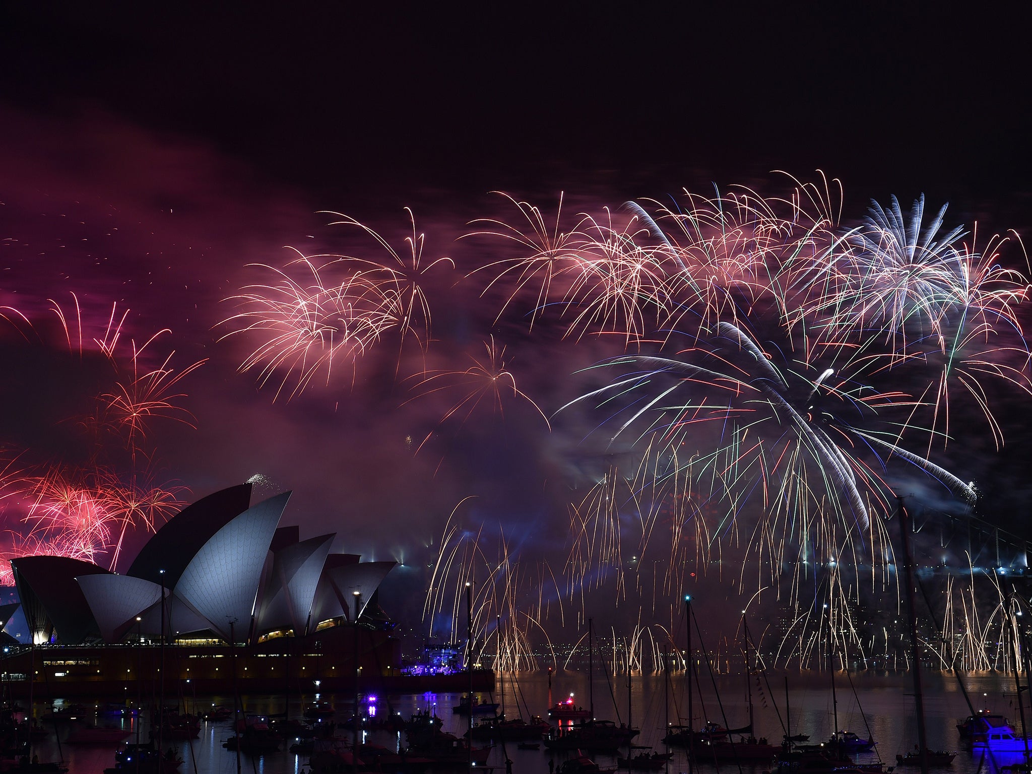 New Year's fireworks erupt over Sydney's iconic Harbour Bridge and Opera House during the traditional fireworks at midnight on January 1, 2015.