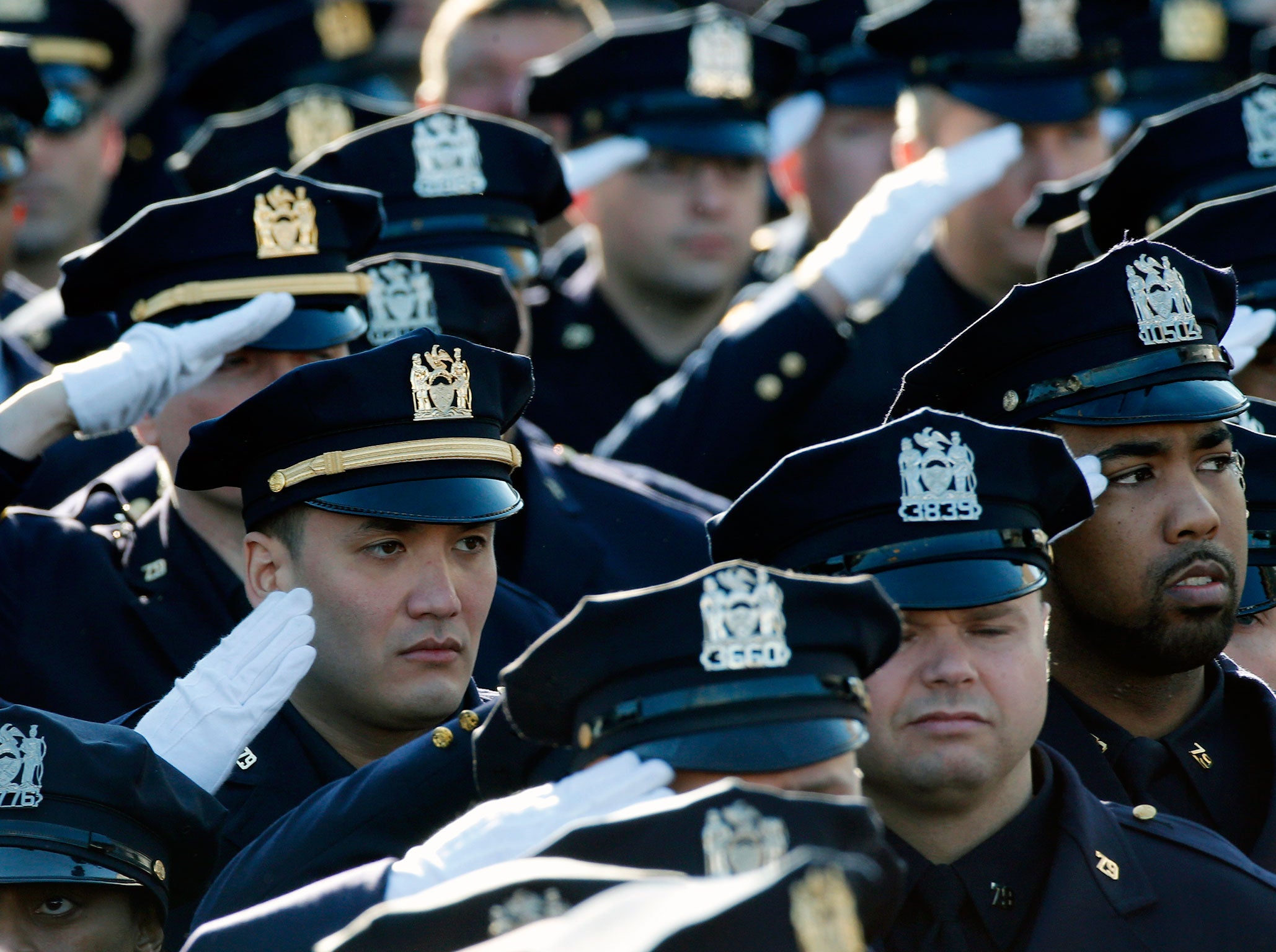 NYPD police salute during national anthem